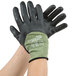 A pair of medium hands wearing Cordova black and green Power-Cor work gloves with Kevlar® and steel fibers.