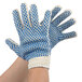 A pair of Cordova work gloves with blue and white dotted PVC coating.