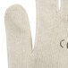 A close up of a Cordova natural cotton work glove with blue nitrile on the palm.