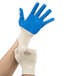 A pair of Cordova natural cotton work gloves with blue nitrile palm coating and blue and white fabric.