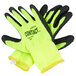 A pair of yellow warehouse gloves with black foam latex coating and black and yellow trim.