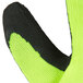 A close up of a pair of Cordova Hi-Vis gloves with black foam latex coating on the palm in neon green.