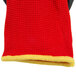 A close-up of a red and yellow knitted fabric glove.