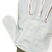 A close up of a Cordova Power-Cor Max Cut Resistant Glove with split leather palm coating and yellow stitching.