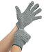 A person wearing Cordova gray warehouse gloves with two-sided criss-cross PVC coating.
