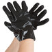 A pair of hands wearing black Cordova sandpaper gloves.