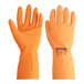 A close-up of a pair of orange Cordova rubber gloves.