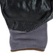 A close up of a black and grey Cordova warehouse glove with a black nitrile palm coating.