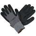 A pair of Cordova Conquest Plus gray and black gloves with nitrile dots on the palms.