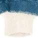 A pair of blue and white knit gloves with a white cuff.