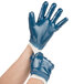 A pair of hands wearing blue Cordova smooth supported nitrile gloves with a white jersey lining.