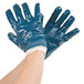A pair of blue Cordova Smooth Supported Nitrile gloves with white palms.