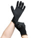 A pair of hands wearing Cordova black gloves with black foam nitrile/polyurethane palms.