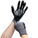 A pair of hands wearing Cordova black gloves with black nitrile palms.