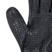 A close up of a black Cordova warehouse glove with black foam nitrile and nitrile dots on the palm.