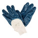 A pair of blue Cordova nitrile gloves with white and blue paint on the palms.