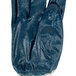 A blue Cordova warehouse glove with white trim.