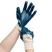 A pair of hands wearing blue Cordova Nitrile gloves.