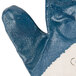 A close up of a blue Cordova warehouse glove with a white surface and blue safety cuffs.