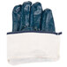 A pair of blue Cordova Smooth Nitrile gloves with white lining in a white bag.