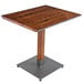 A Lancaster Table & Seating solid wood table with a metal base.