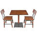 A Lancaster Table & Seating wooden table and chairs with metal legs.