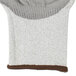 A white and brown HPPE knitted glove with gray palm coating.