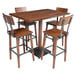 A Lancaster Table & Seating bar height table with four chairs.