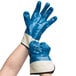 A pack of blue and white Cordova Brawler Smooth Supported Nitrile Gloves with Jersey Lining