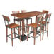 A Lancaster Table & Seating solid wood live edge bar height table with bar chairs around it.