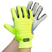 A pair of Cordova medium lime green gloves with black and grey accents on a hand.