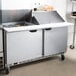 A Beverage-Air stainless steel 2 door mega top sandwich prep table on a counter.
