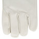 A close up of a pair of white leather gloves with russet leather cuffs.