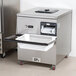 A grey rectangular Campus Products CDM-12K Silvershine Cutlery Dryer / Polisher machine on a counter.