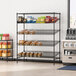 A Regency black epoxy wire shelving unit with food on the shelves.