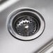 A close-up of the drain on an Advance Tabco hand sink.