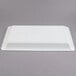 A white plastic tray on a gray background.