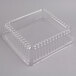 A clear plastic container with a clear plastic square dome lid.