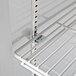 A white shelf with metal rods inside a Horizon Series reach-in refrigerator.