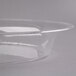 A clear plastic oval catering bowl with a rim.