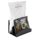 A black Cal-Mil hotel room packet organizer holding two bags of tea.