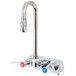 A chrome T&S wall mount faucet with red and blue lever handles.