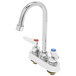 A chrome T&S deck-mounted workboard faucet with two gooseneck spouts and lever handles.