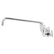 A chrome Equip by T&S wall mount faucet with wrist handles and a long swing spout.