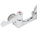 A chrome Equip by T&S wall mount faucet with two red wrist handles.
