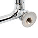 A chrome plated Equip by T&amp;S wall mount faucet with wrist handles.