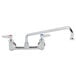 A T&S chrome wall mount faucet with two lever handles.