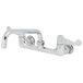 A chrome Equip by T&amp;S wall mount faucet with wrist handles and a swing spout.