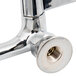A chrome plated Equip by T&S wall mount faucet with wrist handles and a nut on the end.