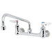 A T&S chrome wall mount faucet with two lever handles.
